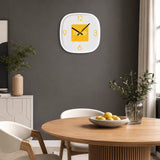 Yellow wall clock above dining table with chairs and dark feature wall