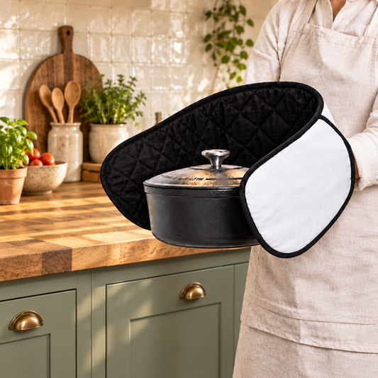 Black and white cotton double oven glove being used to carry a casserole pot in a modern kitchen