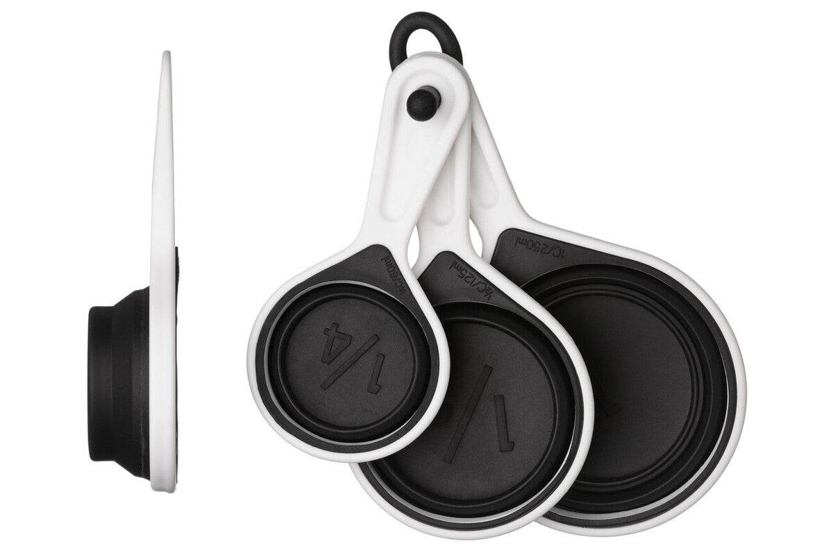 Silicone measuring cups set of 4 in black collapsed on white background