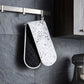 Black and white double oven gloves hanging in a modern kitchen for heat protection