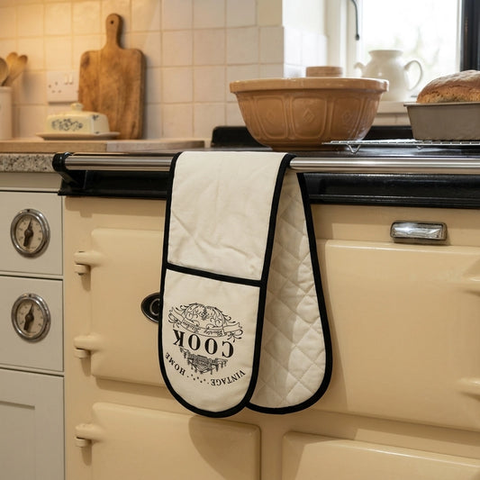 Cream quilted double oven glove with vintage Cook logo hanging on a cream Aga oven door handle