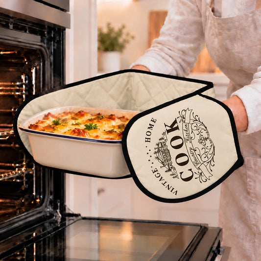 Cream double oven glove with vintage Home Cook print used to pull a cheesy baking dish from a hot oven