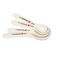 Cream kitchen measuring spoons set of 4 with labeled sizes on white background