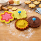 Pink flower and yellow round cookie cutter stamp set with stamped rabbit and flower cookies