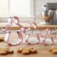 Three gingerbread lady cookie cutters in small, medium and large sizes with baked cookies in a kitchen