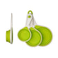 Green measuring cups set of 4 collapsed and folded on white background