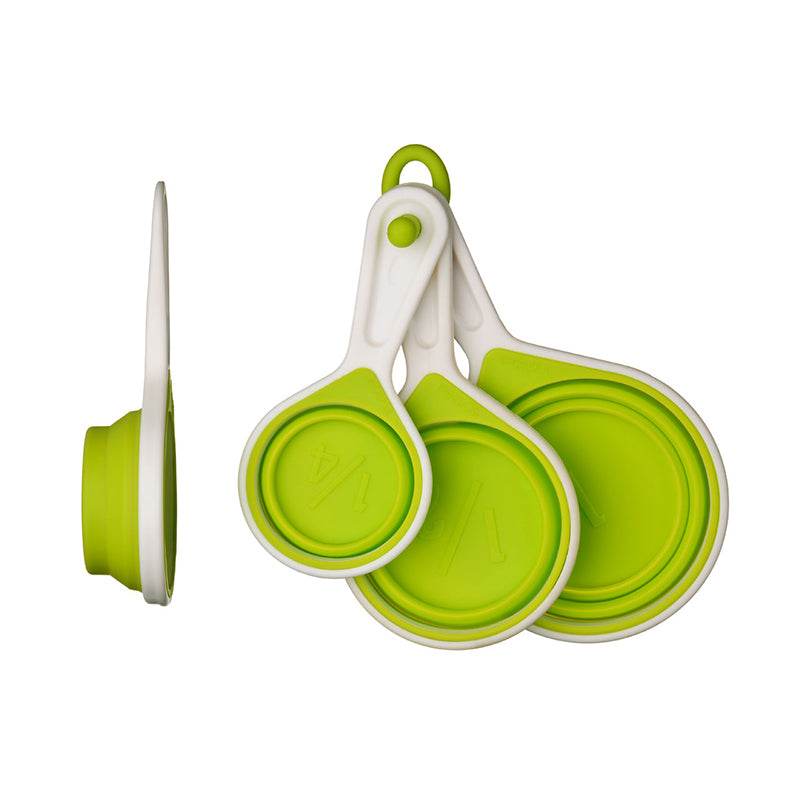 Green measuring cups set of 4 collapsed and folded on white background