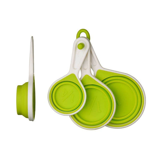 Green measuring cups set of 4 collapsed and folded on white background