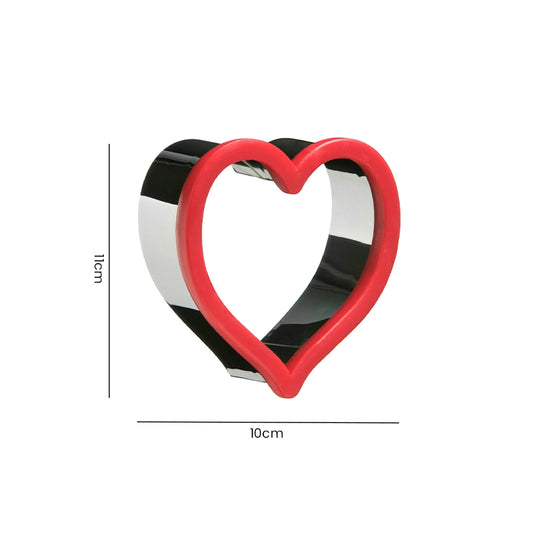 Stainless steel heart cookie cutter with red rim measuring 10cm wide and 10cm tall