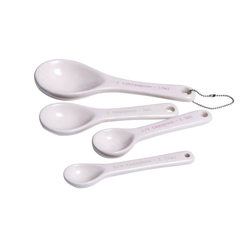 White ceramic measuring spoons set of 4 with hanging ring on white background