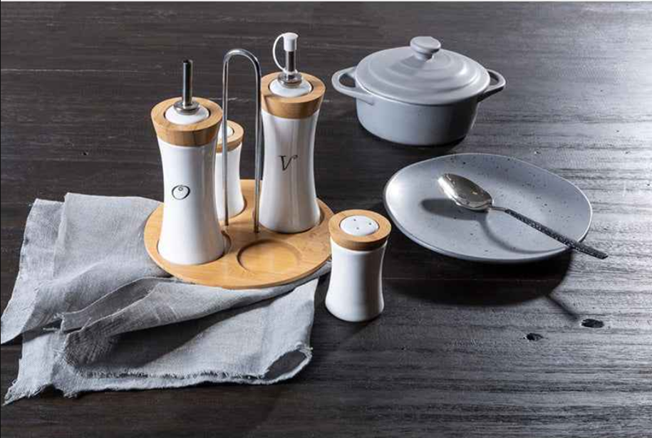 Kitchen table accessories featuring oil and vinegar dispensers, seasoning shakers and ceramic serveware