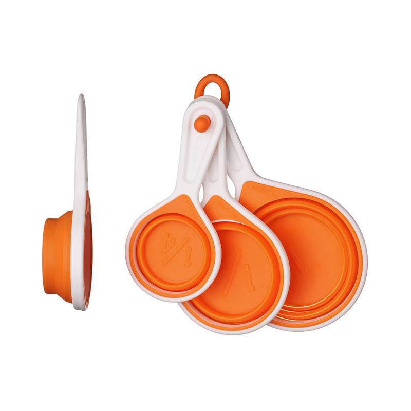 Silicone measuring cups set of 4 in orange collapsed on white background