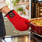 Red single oven glove with embroidered badge used to remove a casserole dish from a hot oven