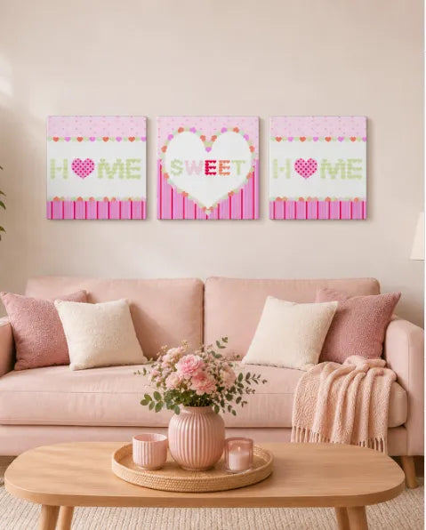 Pink living room decor with Home Sweet Home wall art, sofa, cushions and wooden coffee table