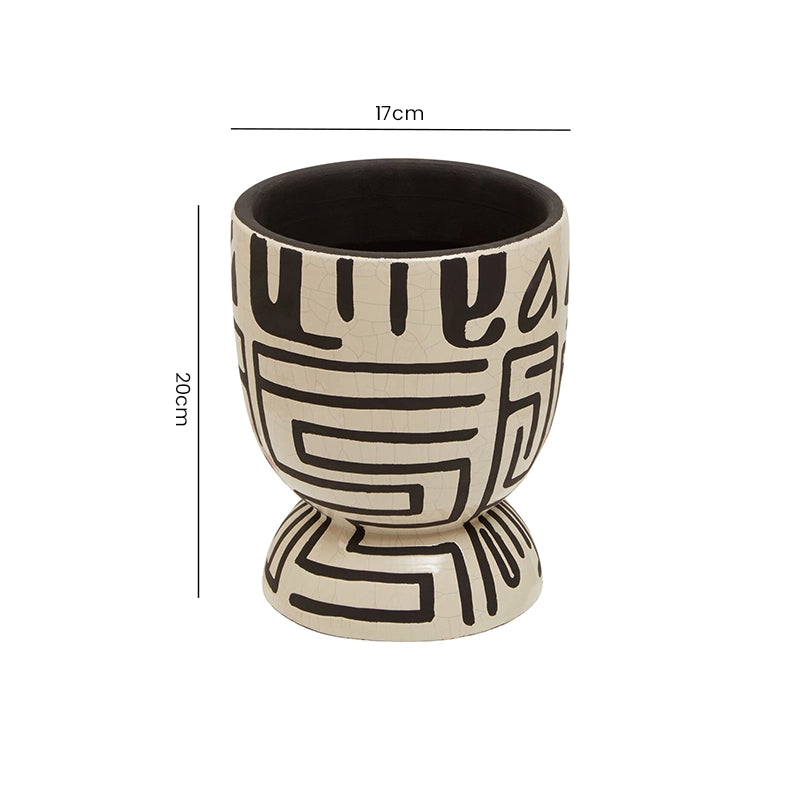 Size reference for a white and black geometric patterned planter with height and width measurements labelled
