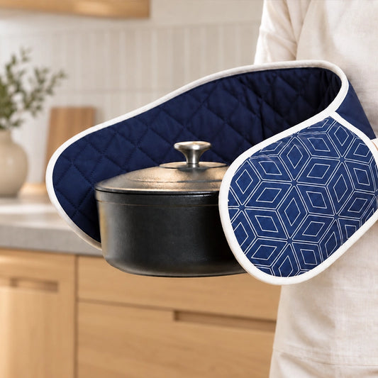 Navy blue double oven mitts with geometric cube pattern wrapped around a black cooking pot with lid