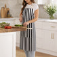 woman wearing white and black apron chopping vegetables in kitchen, vertical stripe cotton cooking apron