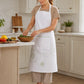 Woman wearing a white kitchen apron with green embroidered floral pattern and front pocket while preparing food at a kitchen counter